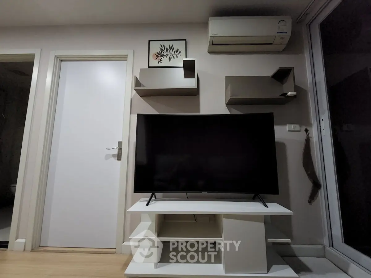 Modern living room with sleek TV setup and air conditioning