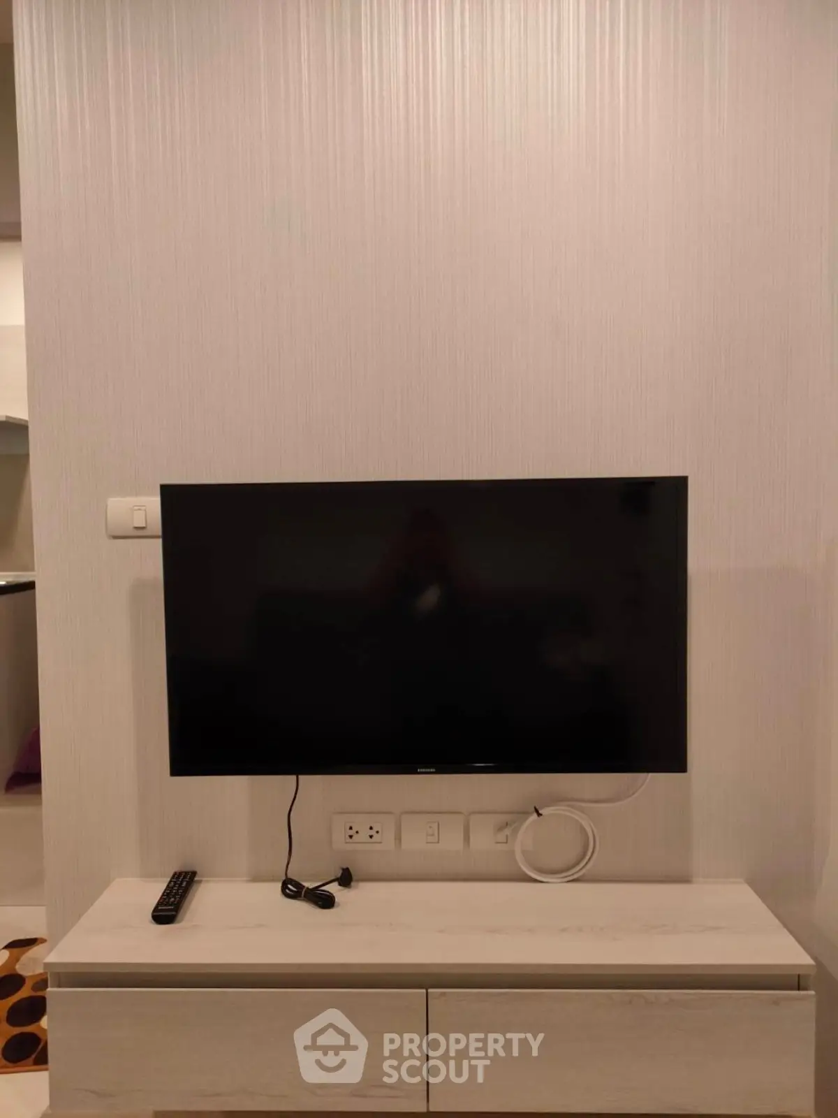 Modern living room with wall-mounted TV and sleek console table