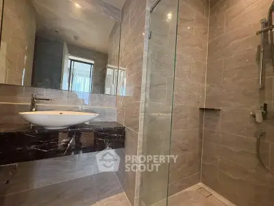 Modern bathroom with sleek design and glass shower enclosure