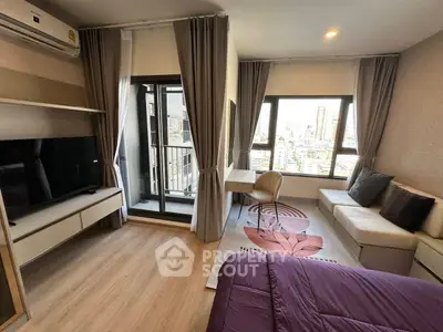 Modern bedroom with city view, balcony access, and stylish decor