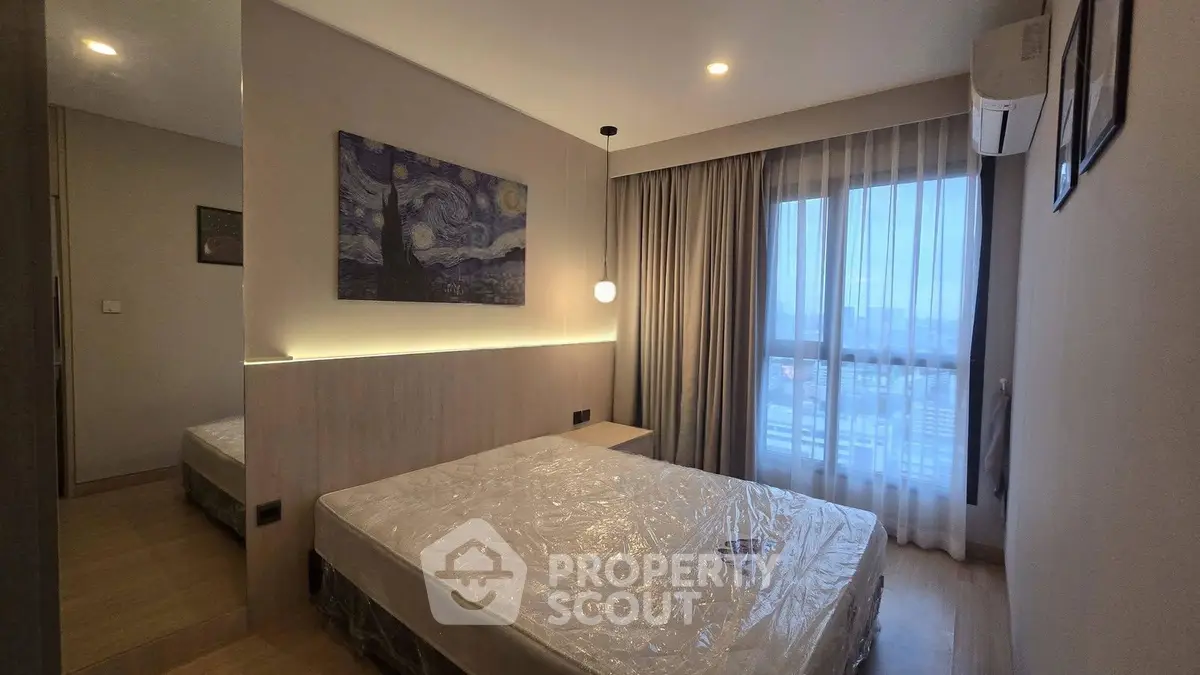 Modern bedroom with large window and stylish decor