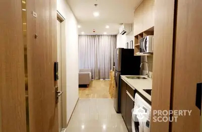 Modern apartment hallway with kitchen appliances and washing machine