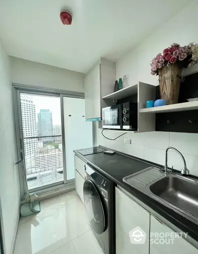 Modern kitchen with city view, featuring sleek appliances and stylish decor