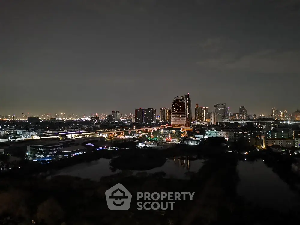 Stunning city skyline view with illuminated buildings at night, perfect for urban living enthusiasts.