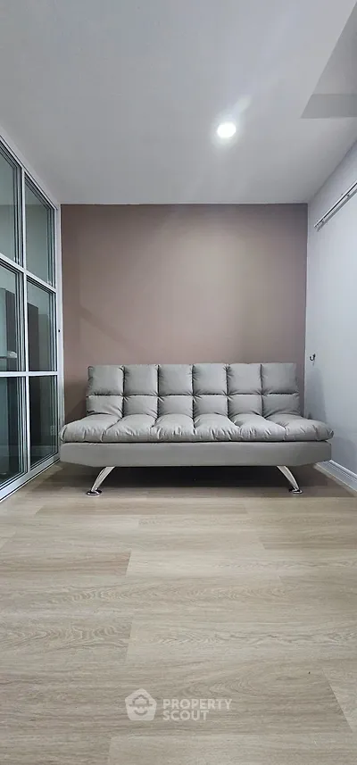 Modern living room with sleek sofa and wooden flooring
