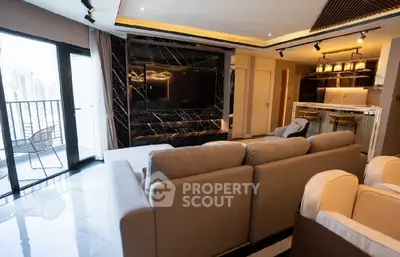 Luxurious modern living room with marble accents and open kitchen layout