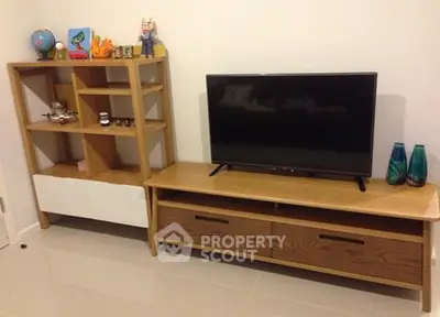 Modern living room with stylish wooden TV stand and bookshelf