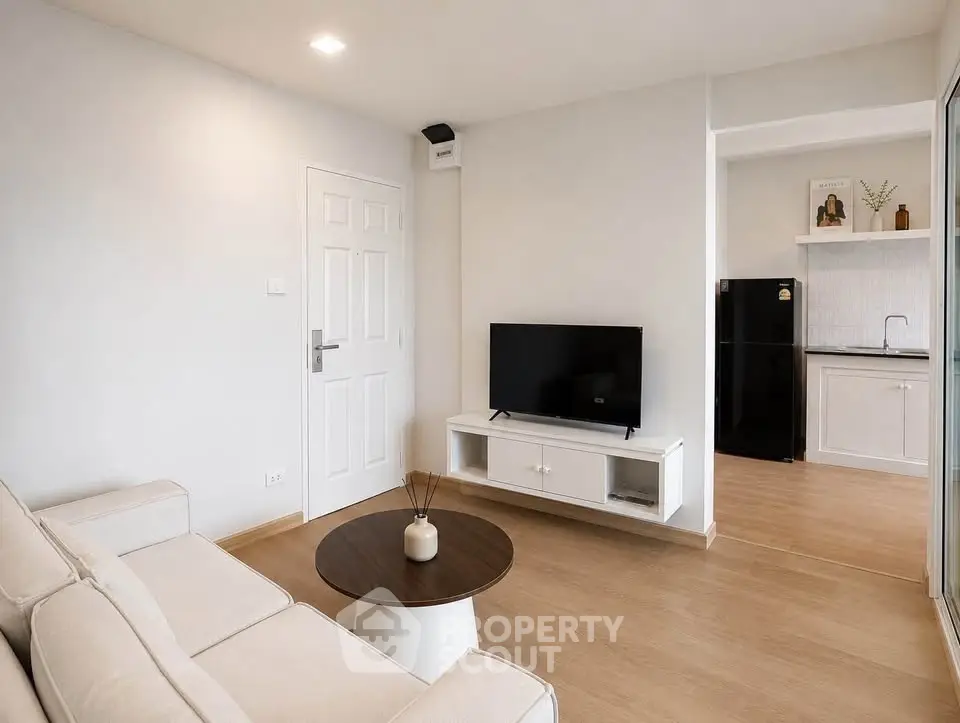 Modern living room with sleek design and open kitchen layout