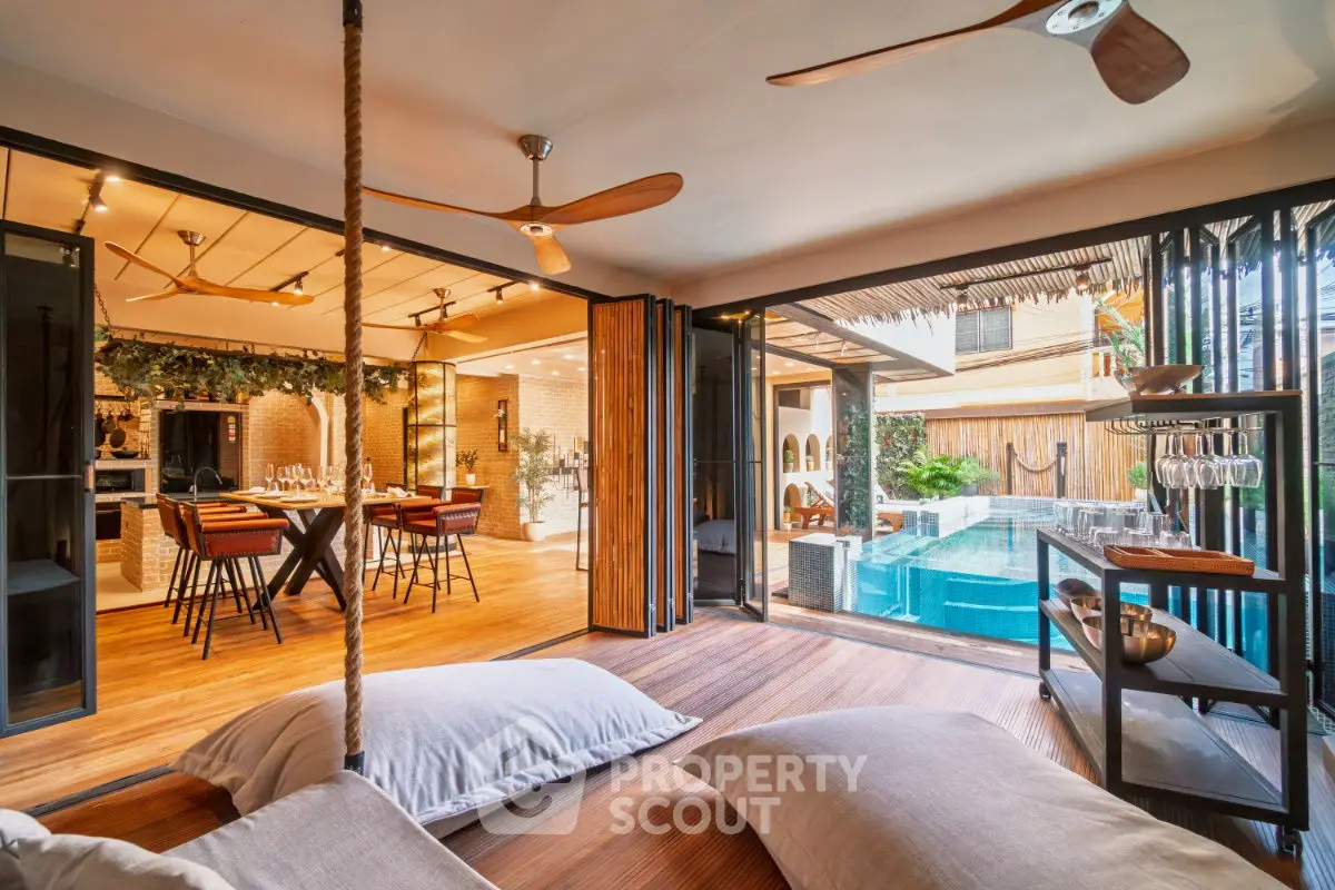 Luxurious open-plan living area with pool view and modern decor