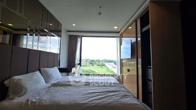 Luxurious bedroom with panoramic window offering stunning green views, modern design and ample natural light.