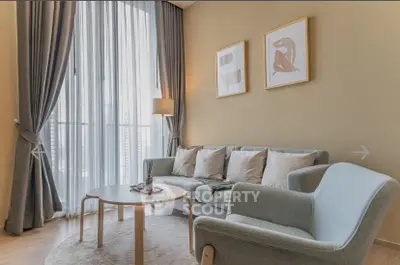 Stylish living room with modern furniture and large windows for natural light.