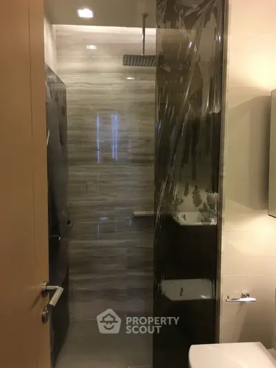 Modern bathroom with sleek shower design and contemporary fixtures.