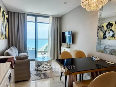 Luxurious living room with ocean view, elegant decor, and modern furnishings in a high-rise apartment.