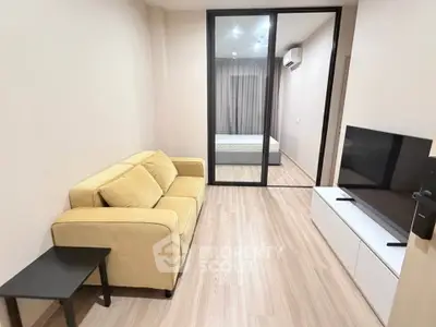 Modern living room with cozy yellow sofa and sleek TV setup