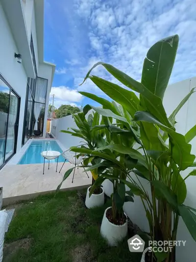 Modern villa with private pool and lush garden, perfect for relaxation and luxury living.