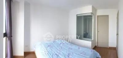 Bright bedroom with large window and cozy bed in modern apartment