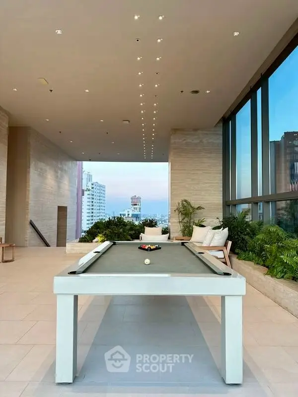 Luxurious rooftop with pool table and stunning city view, perfect for entertainment and relaxation.