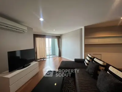 Modern living room with sleek furniture and balcony access