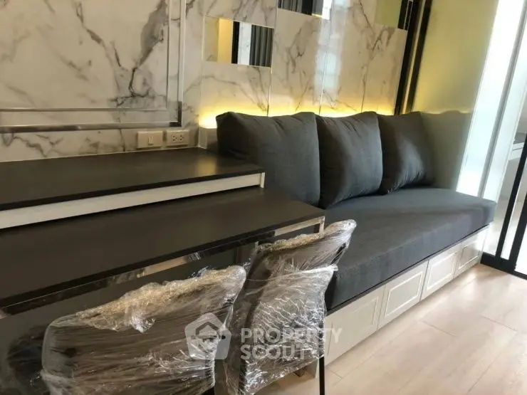 Modern living room with stylish sofa and marble accents