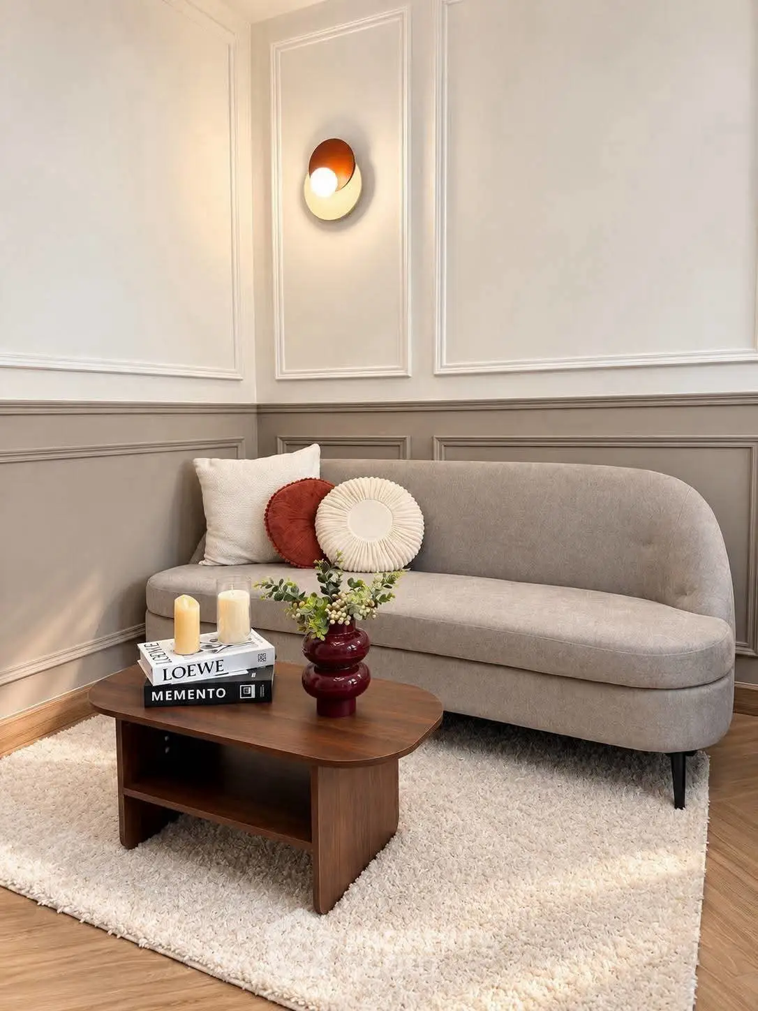 Stylish living room with modern sofa, elegant wall decor, and cozy coffee table setup.