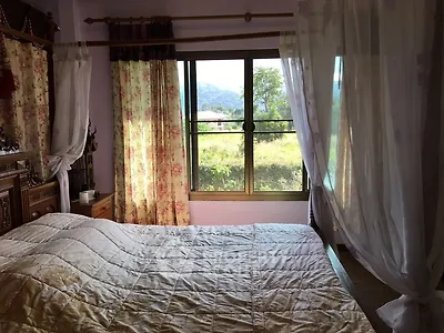 Cozy bedroom with scenic window view and elegant curtains