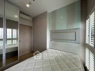 Modern bedroom with mirrored closet and natural light