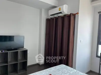 Modern bedroom with air conditioning and TV, featuring stylish curtains and sleek furniture.