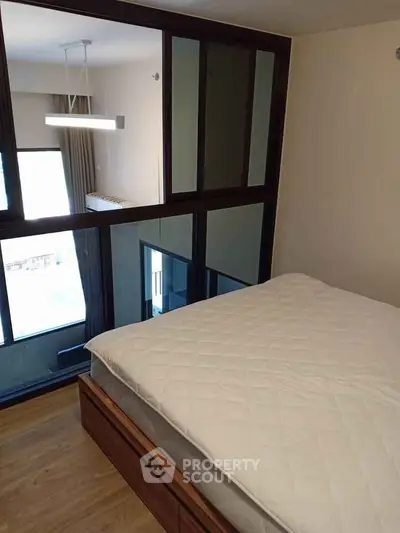 Modern bedroom with large windows and minimalist design