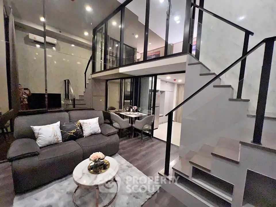 Modern duplex living room with stylish decor and open staircase