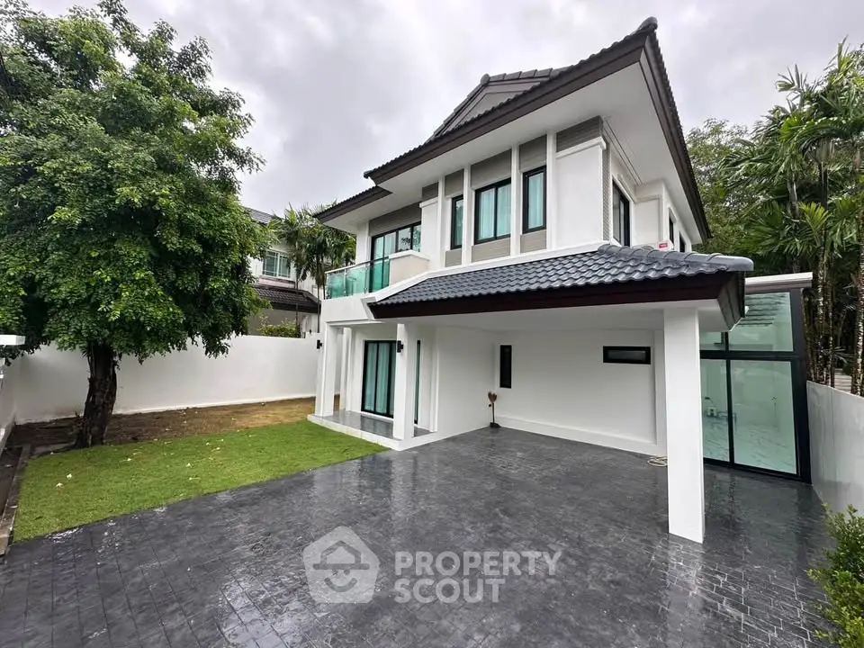 Stunning modern two-story house with spacious driveway and lush garden