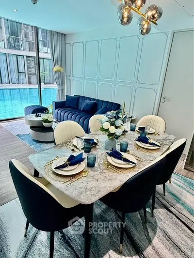Luxurious dining area with elegant table setting and pool view, perfect for entertaining guests.