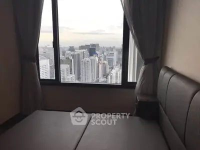 Stunning city view from a modern bedroom window in a high-rise apartment.