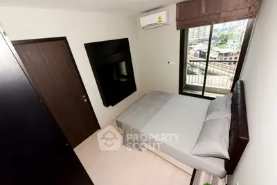 Modern bedroom with balcony view in urban apartment
