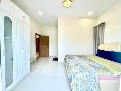 Spacious modern bedroom with elegant wardrobe and cozy bed setup