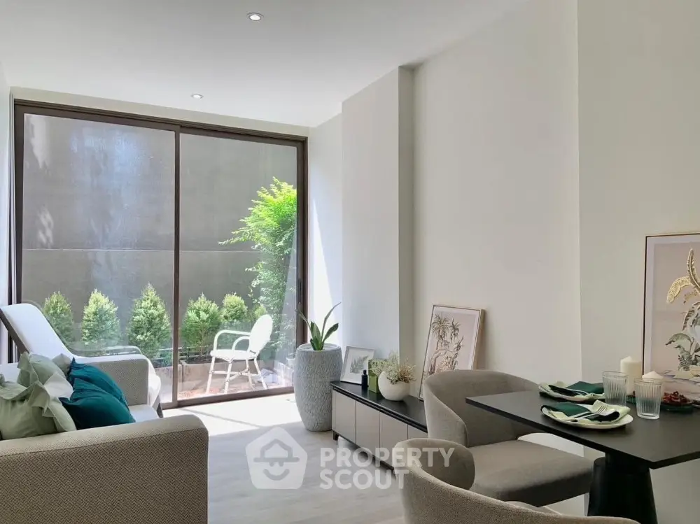 Modern living room with large window and stylish furniture, perfect for urban living.
