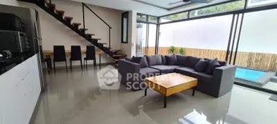 Modern living room with sleek staircase and pool view, featuring stylish furniture and open layout.