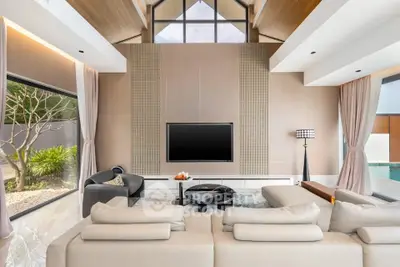 Luxurious modern living room with high ceilings and large windows overlooking a serene garden and pool.
