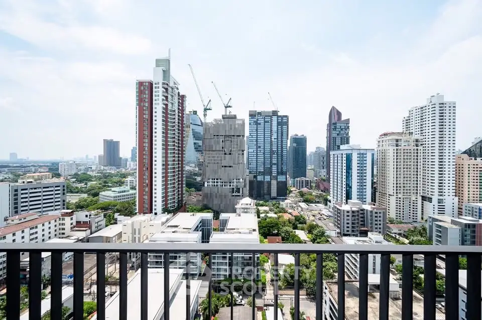 Stunning cityscape view from a high-rise balcony showcasing modern skyscrapers and urban skyline.