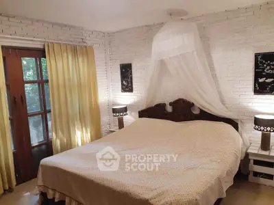 Charming bedroom with rustic brick walls and elegant canopy bed