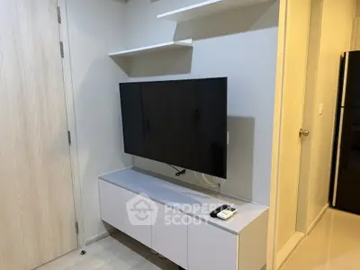 Modern living room with wall-mounted TV and sleek storage unit