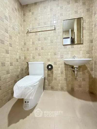 Spacious bathroom with modern fixtures and tiled walls