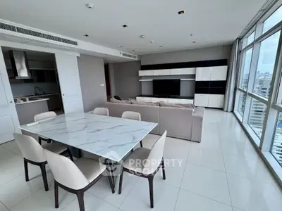 Spacious modern living room with city view, open layout, and elegant dining area.