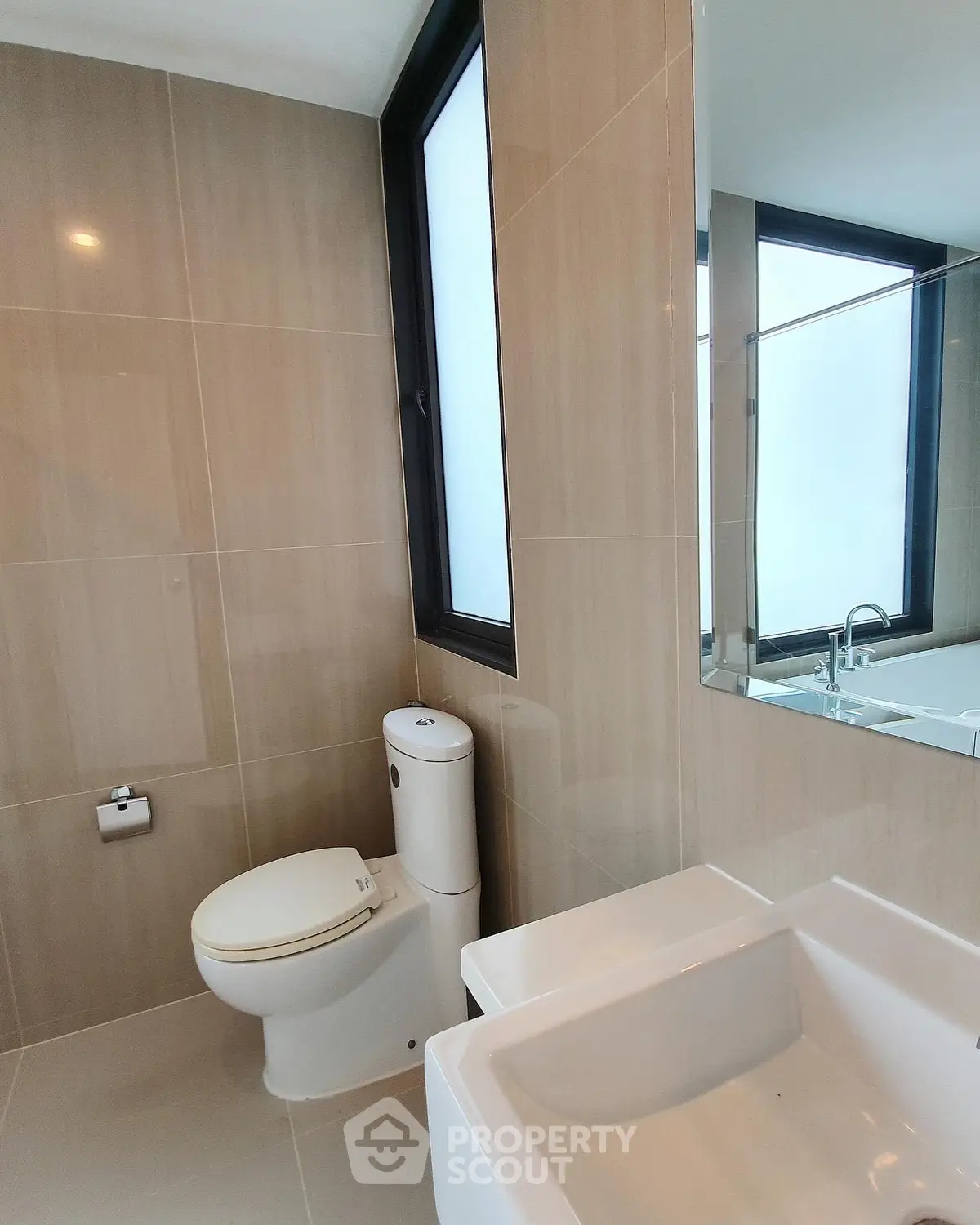 Modern bathroom with sleek fixtures and large window for natural light.
