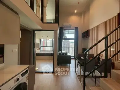 Modern duplex apartment with open living area and washing machine