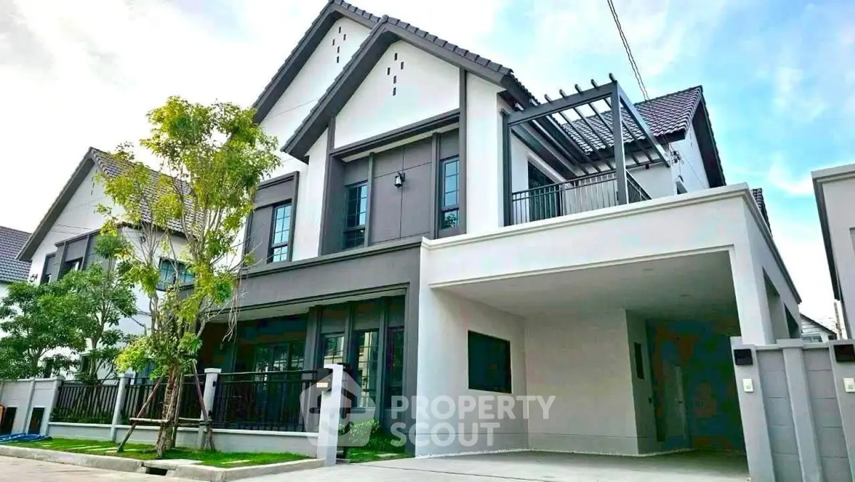 Modern two-story house with sleek design and spacious driveway in a serene neighborhood.