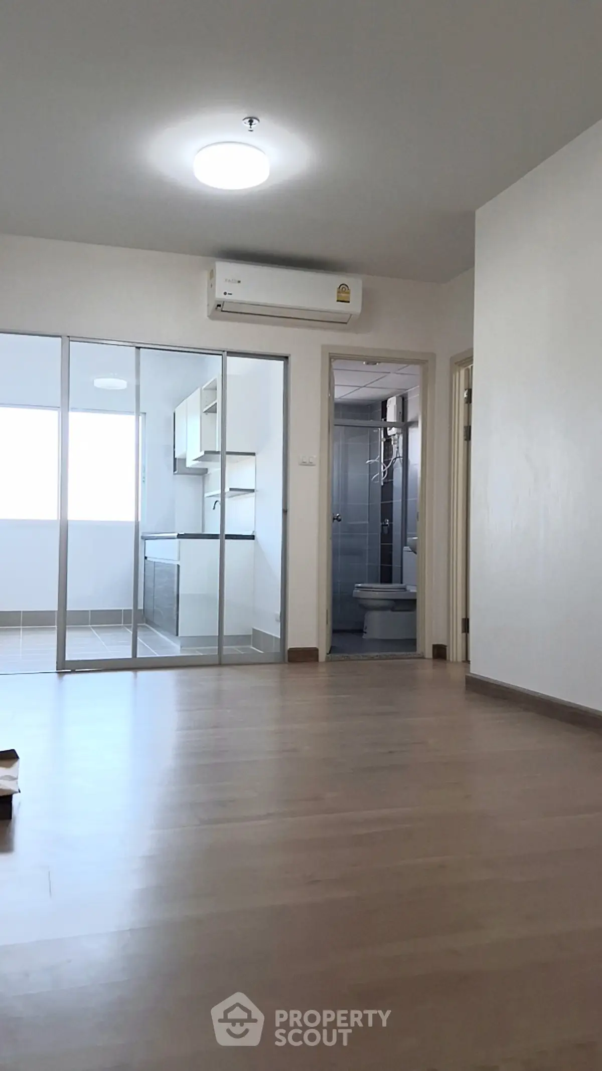 Spacious modern apartment with open layout and sleek kitchen design.