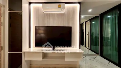 Modern living room with sleek TV setup and air conditioning unit