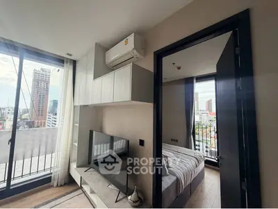 Modern apartment interior with city view, featuring a cozy bedroom and stylish living area.