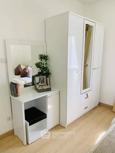 Bright bedroom with modern white wardrobe and vanity desk