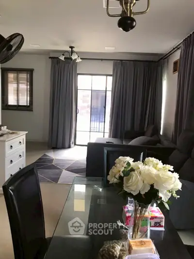 Elegant living room with modern decor and large windows for natural light.
